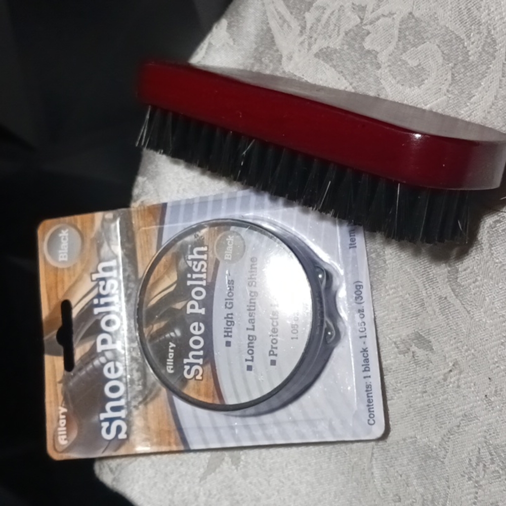Black shoe Polish with a brush